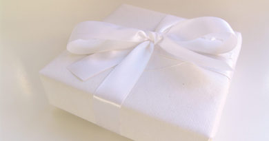 present wrapped in white with satin ribbon