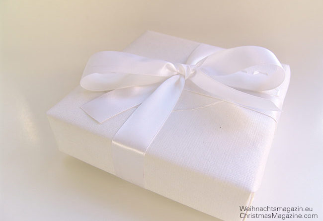 present wrapped in white with satin ribbon