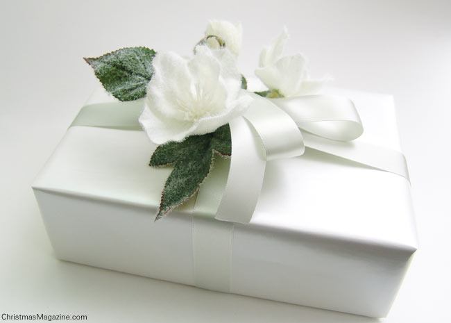 Hellebores, wrapped Christmas gift, white