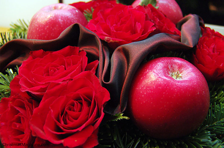 Christmas arrangement with red roses and Pink Lady apples. 
