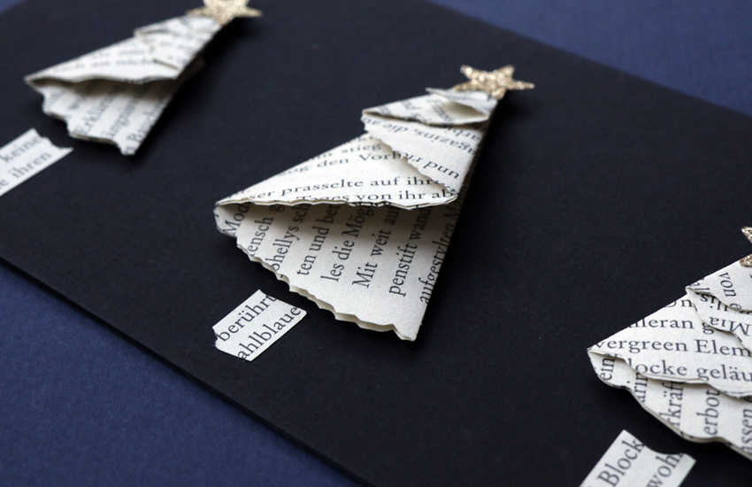 handmade Christmas card with folded trees from book pages
