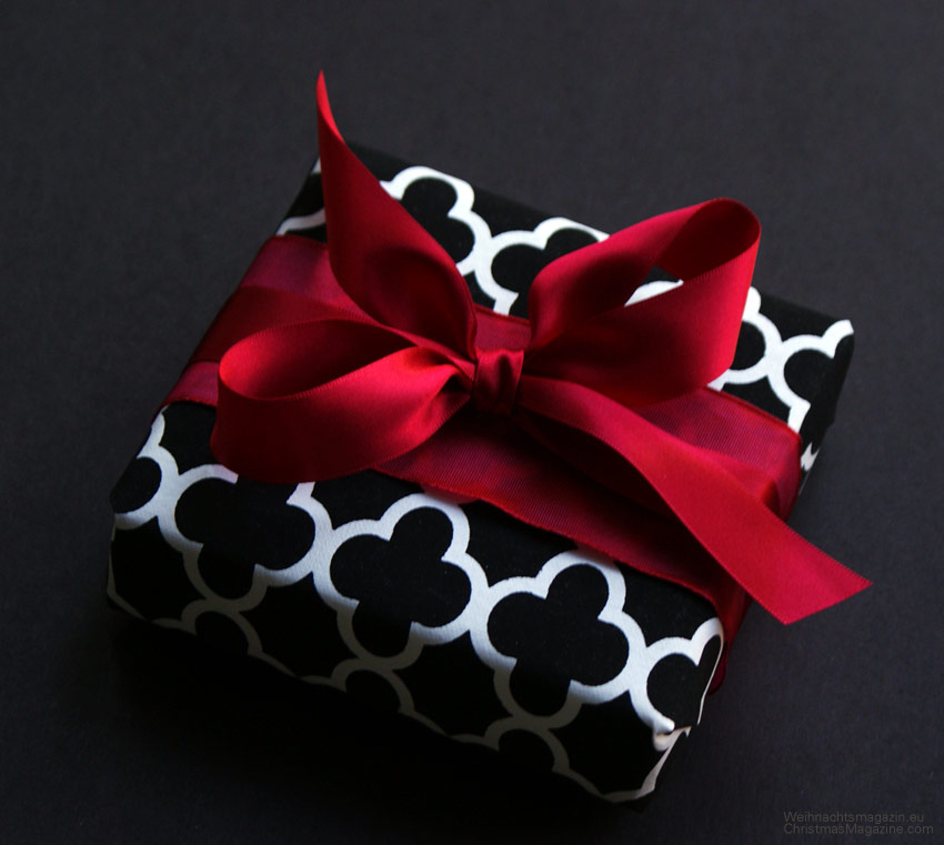 gift wrapping with contrasting packaging, paper with  black & white paper, red ribbon