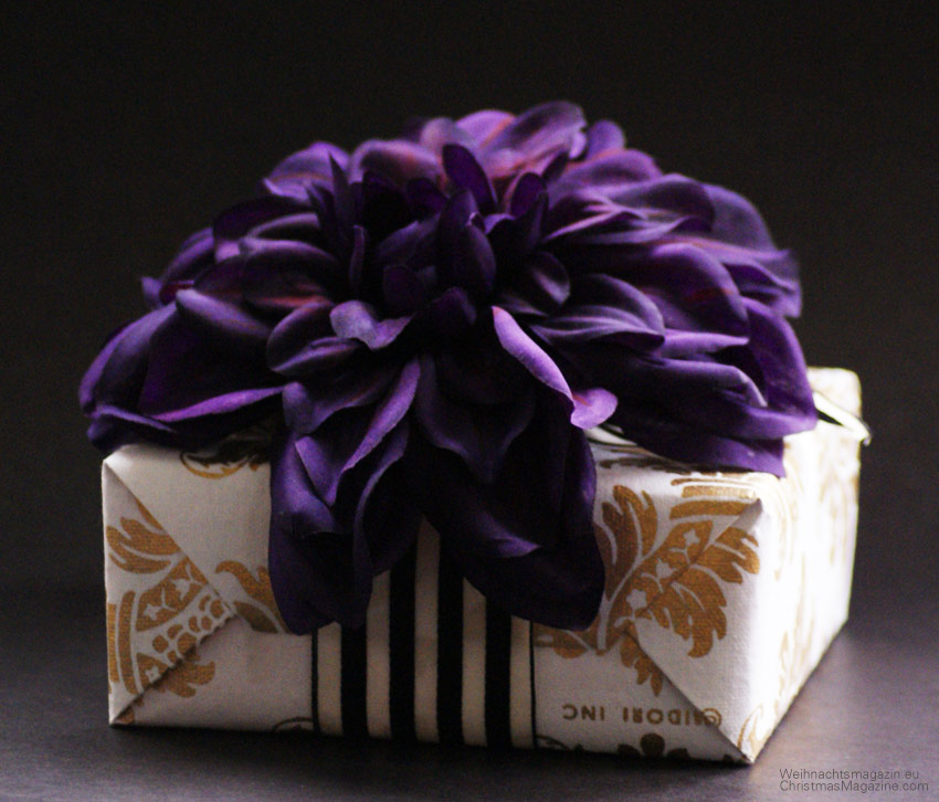 gift wrapping with contrasting packaging, paper with gold brocade pineapple print, large chrysanthemum