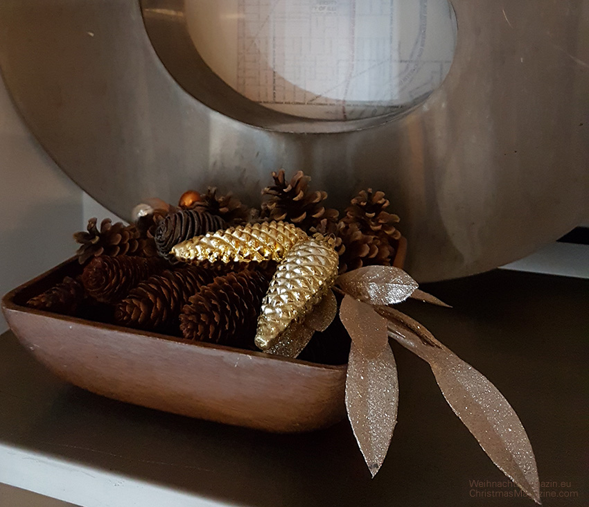 pine cone arrangement in wooden bowl