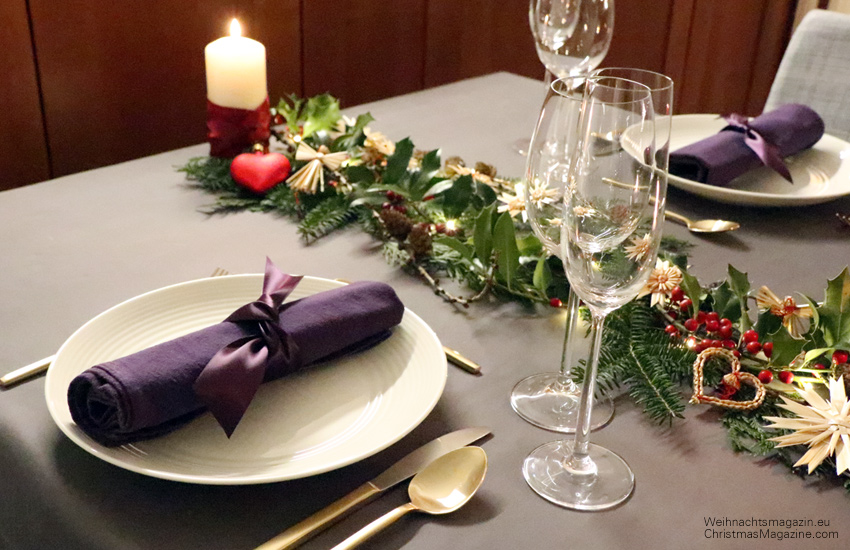 straw stars, pinecones, traditional German Christmas table setting, napkin tied with ribbon