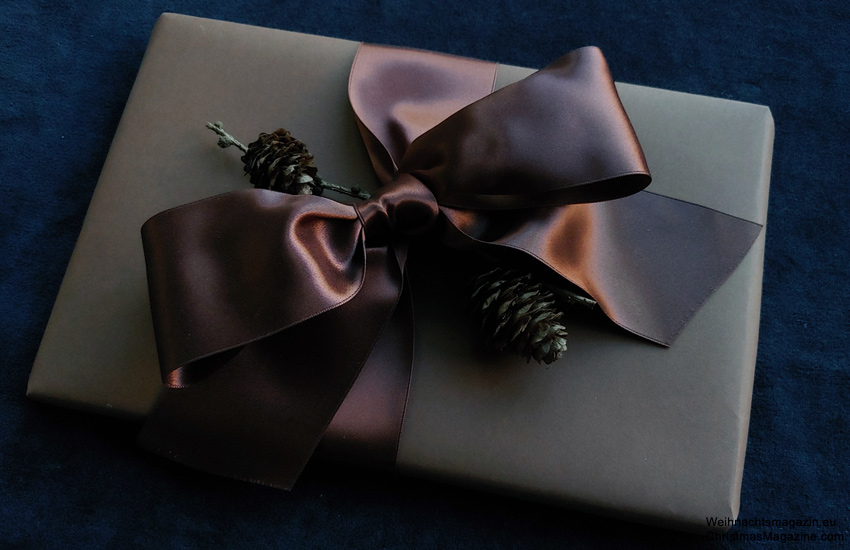 gift wrapped in brown paper, brown satin bow, tiny pinecones