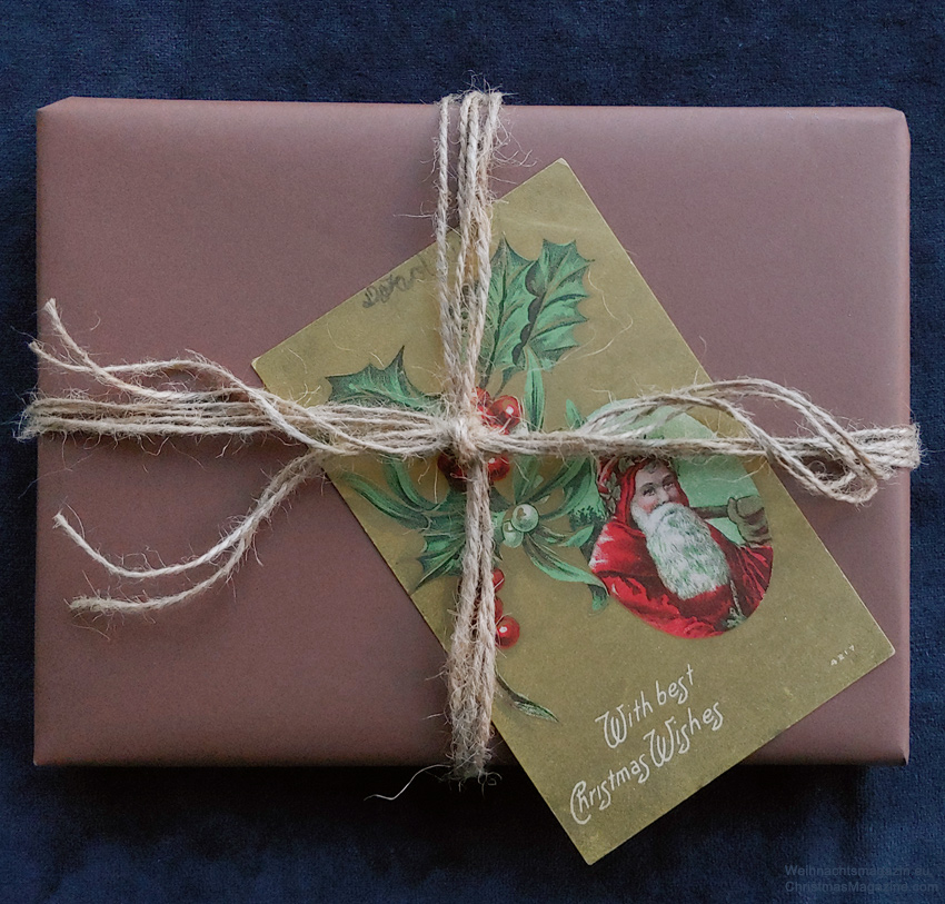 gift wrapped in brown paper decorated with a vintage postcard