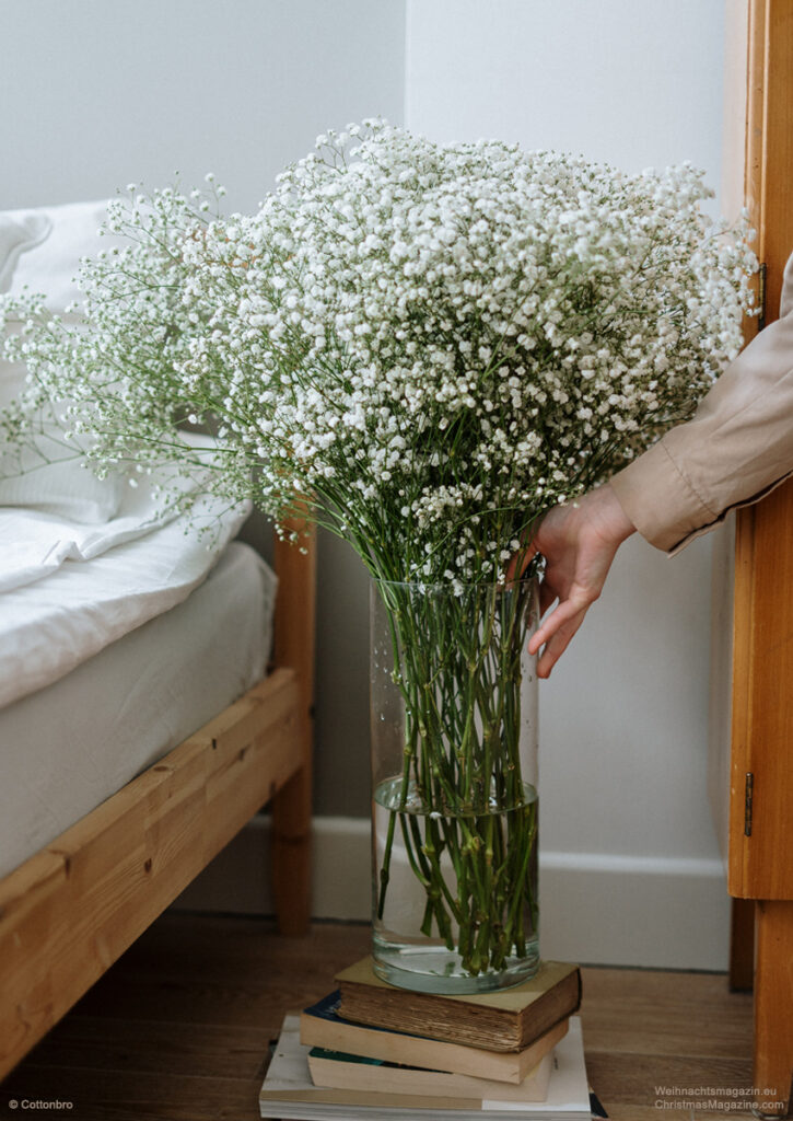 baby's breath bouquet in vase, stack of books